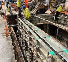 Workers smoothing wet reinforced concrete surface
